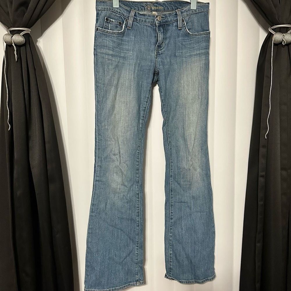 Bebe women’s denim blue jean flare bottoms , rhinestones on back pockets